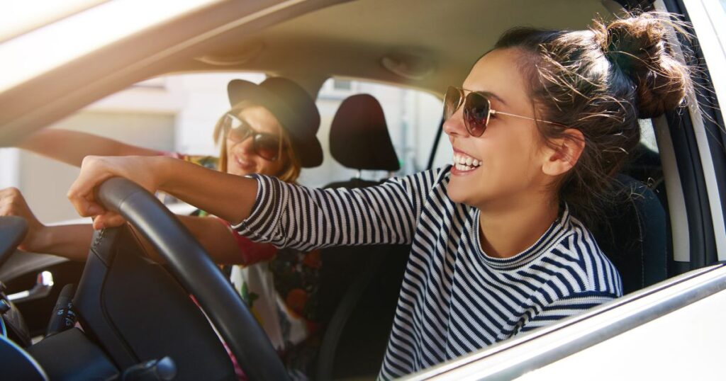 People driving and smiling.