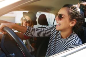 People driving and smiling.